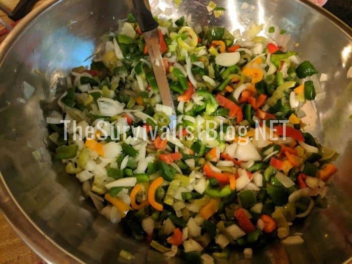 mixing veggies into a bowl to make homemade salsa