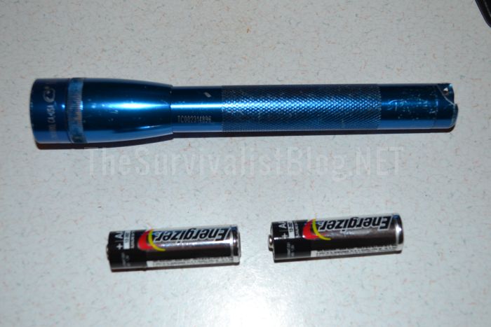 maglite with batteries next to it