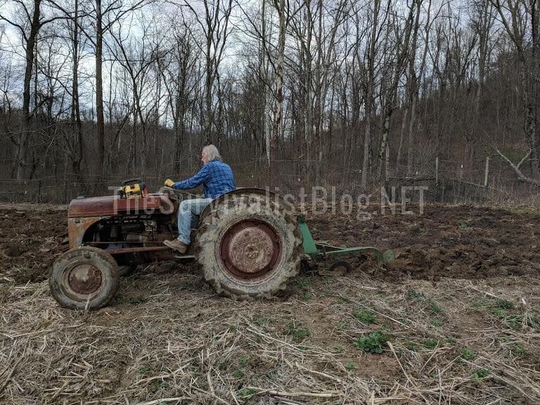 using a tractor to plow the garden