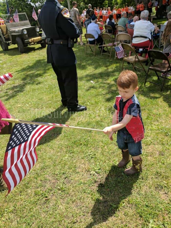 little boy waving the American flag