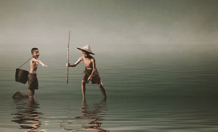 two Vietnamese boys spearfishing