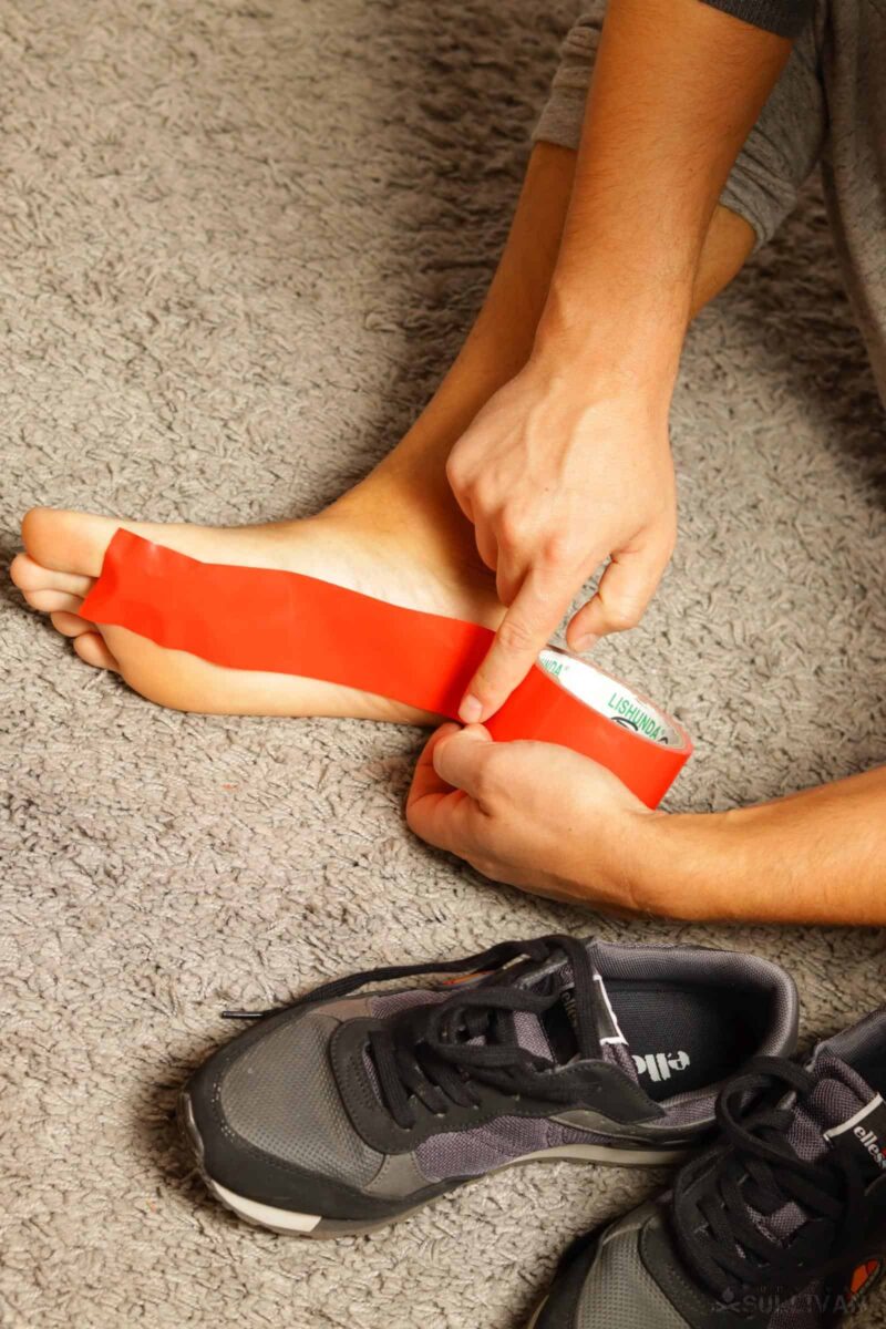 sticking duct tape over sole and heel