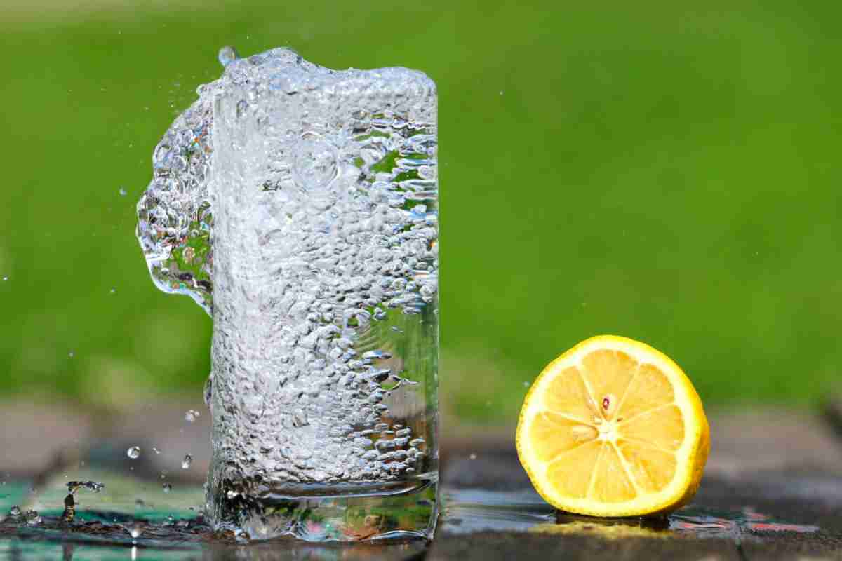 water in glass with lemon wedge