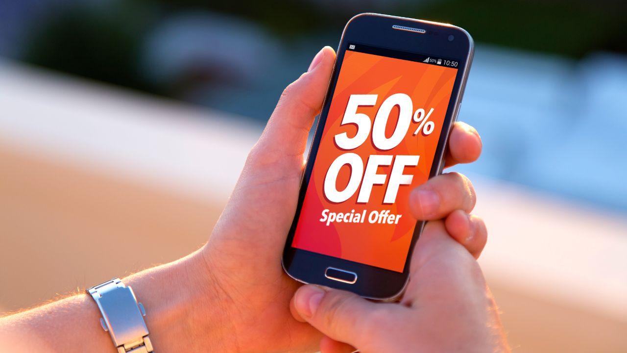 girl holding a phone with 50% sale advertising