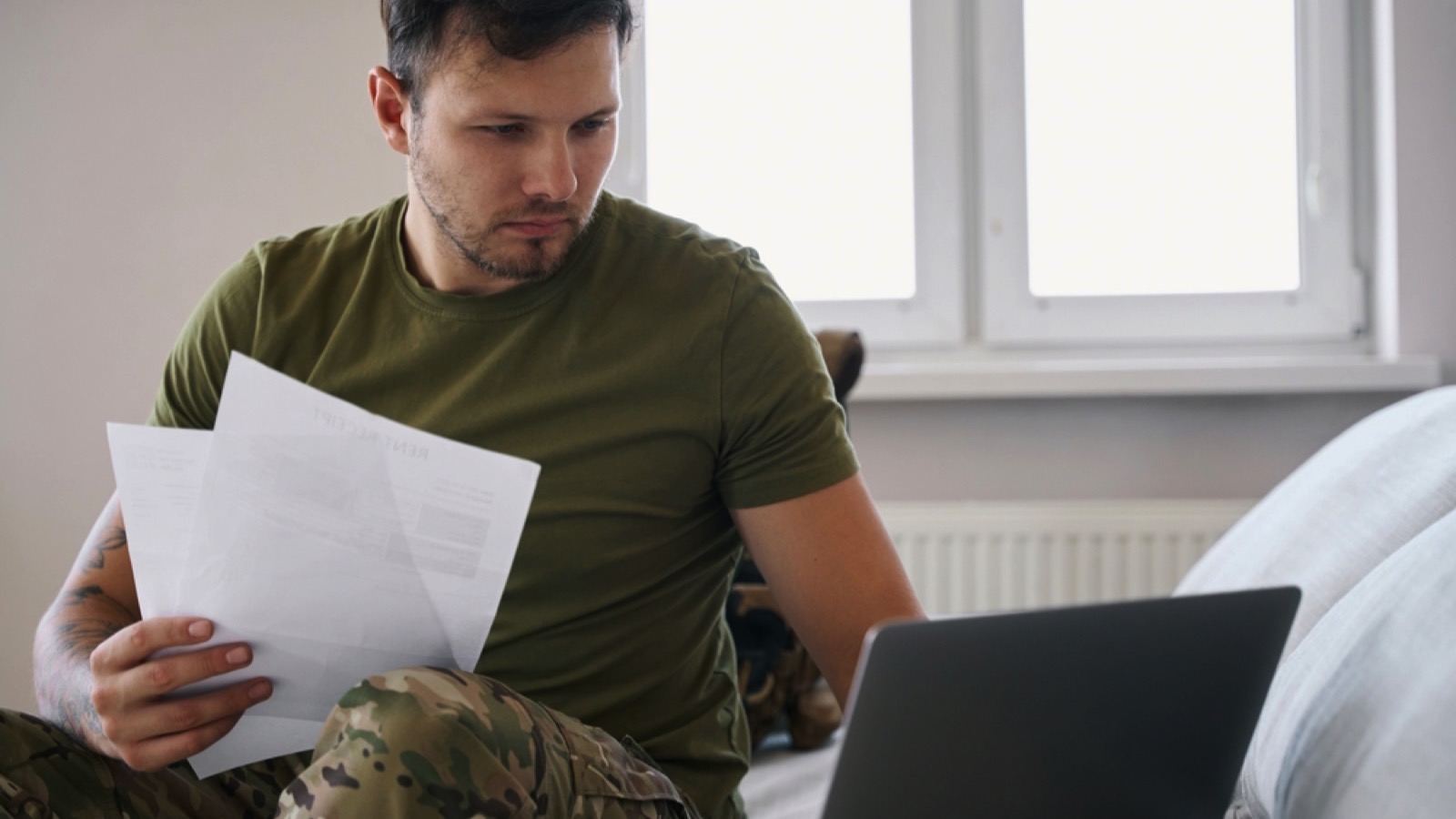 Army combatant holding documentation