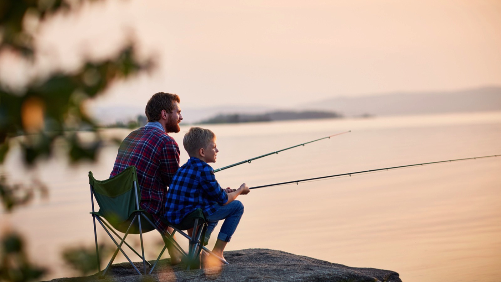Man teaching son fishing