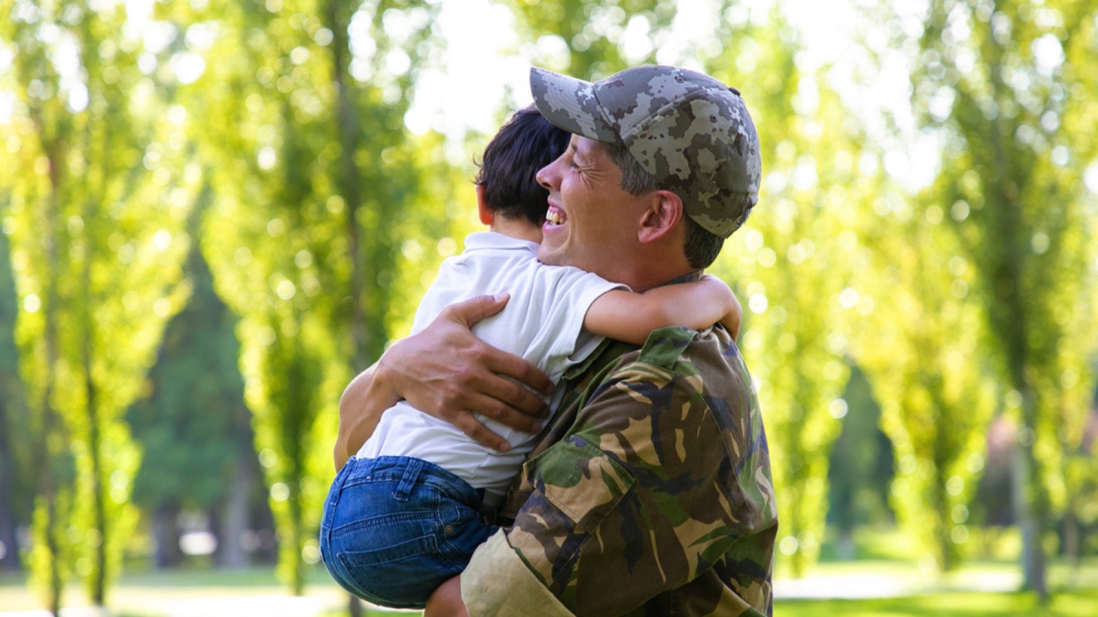 Military man hugging his son