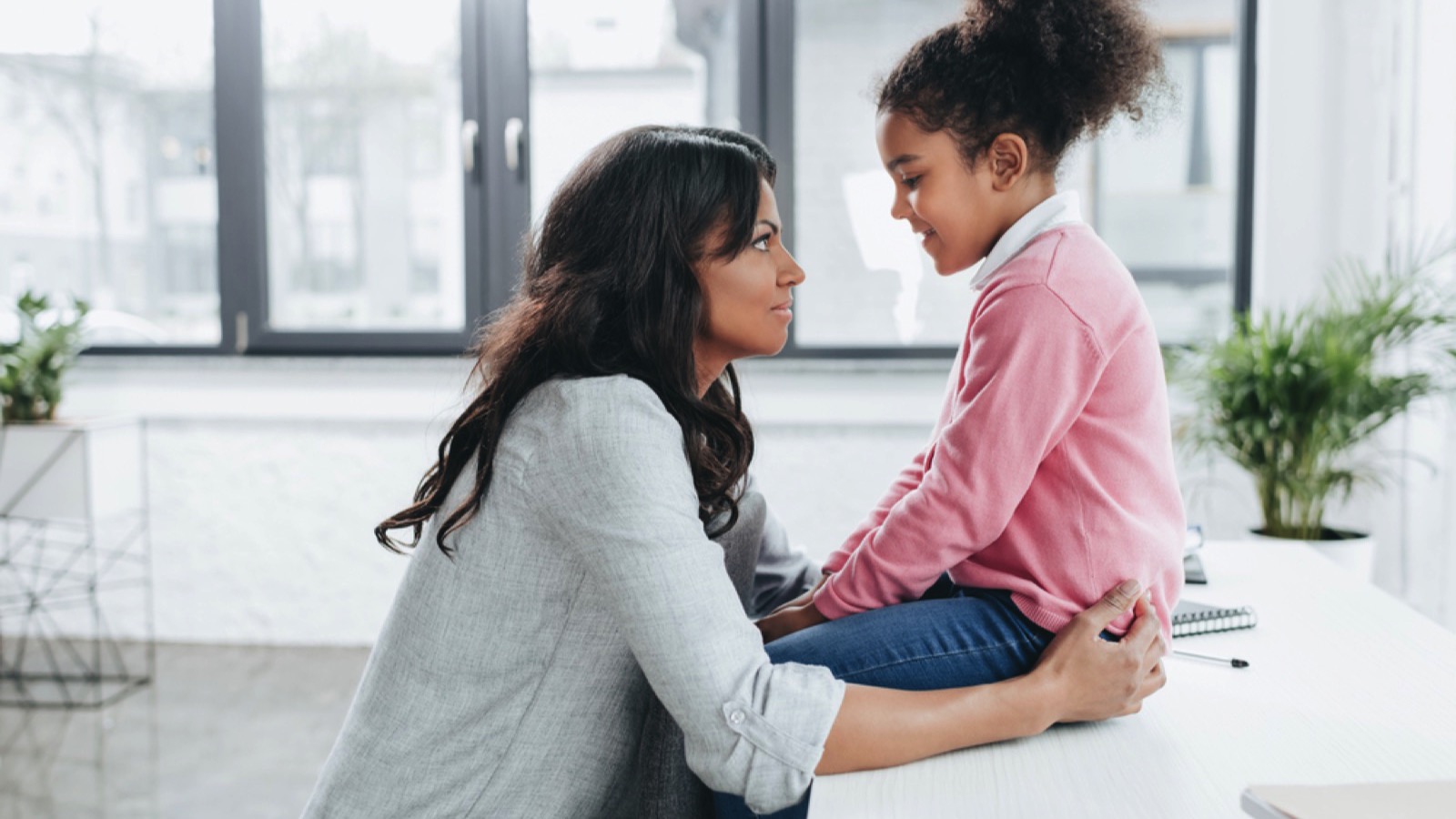 Mother talking to daughter boosting confidence