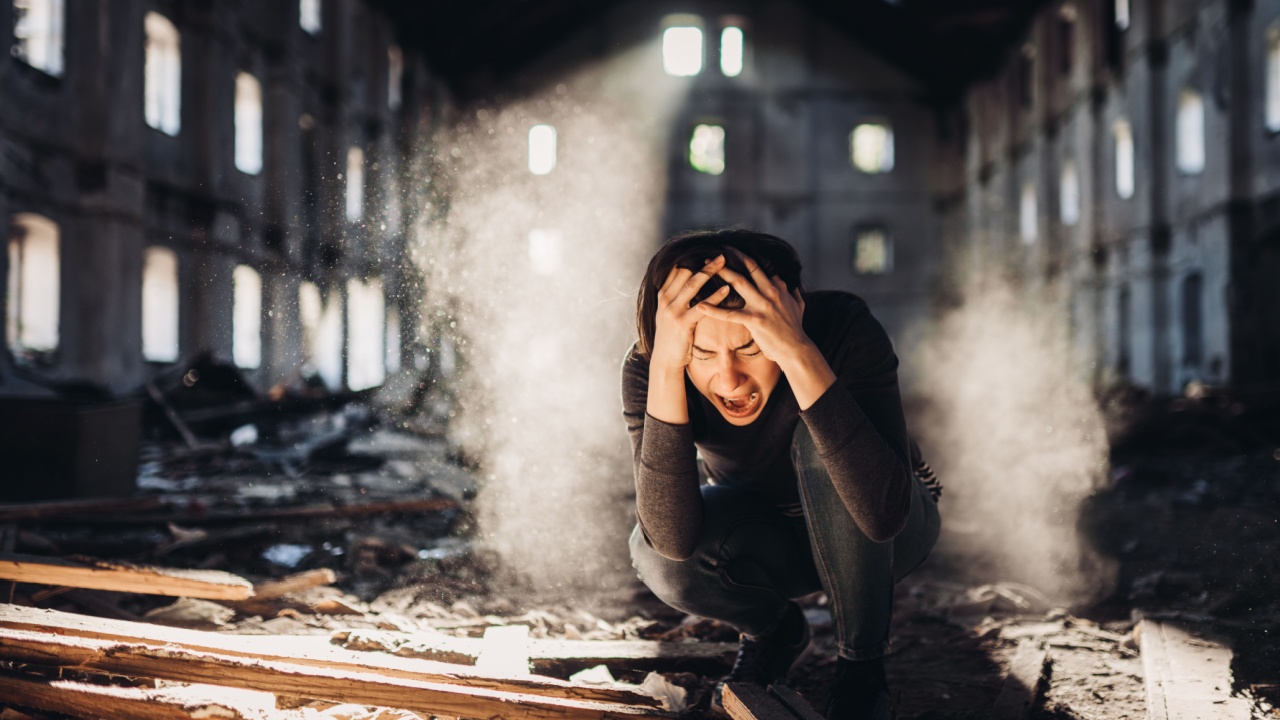 Sad depressed person in abandoned destroyed building crying. Emotional portrait. Screaming woman in excruciating pain. Problem, stress and disappointment. Disaster in life, lost and grief. Madness and trauma