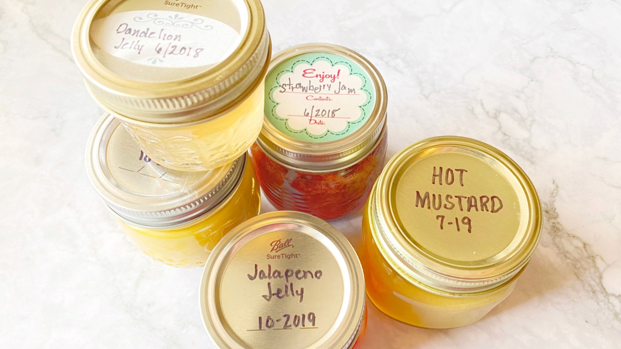 homemade canned jellies and hot mustard labeled with month and year