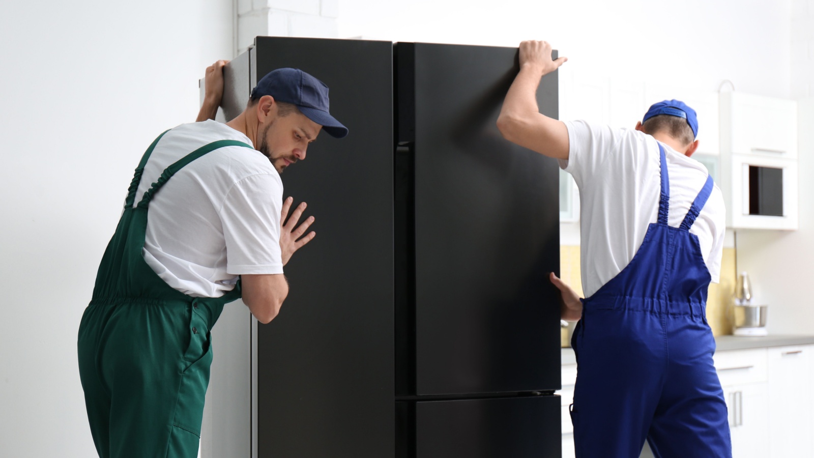 Men moving a fridge freezer