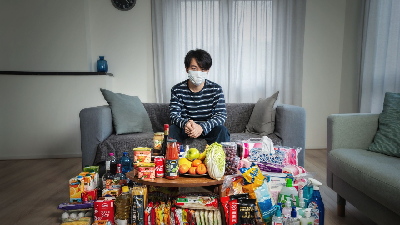 man sat in front of his stockpile of food