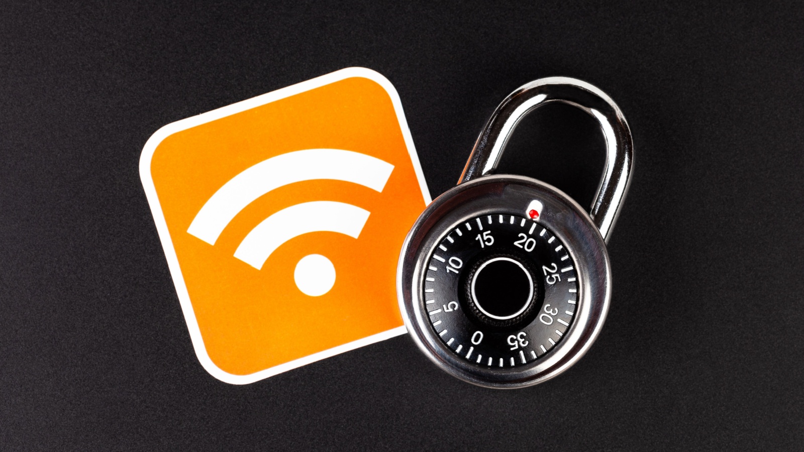 WiFi wireless network security simple abstract concept. Wifi Connection signal symbol and a coded padlock laying on black background. Securing, mobile internet data safety in public hotspots, hacking