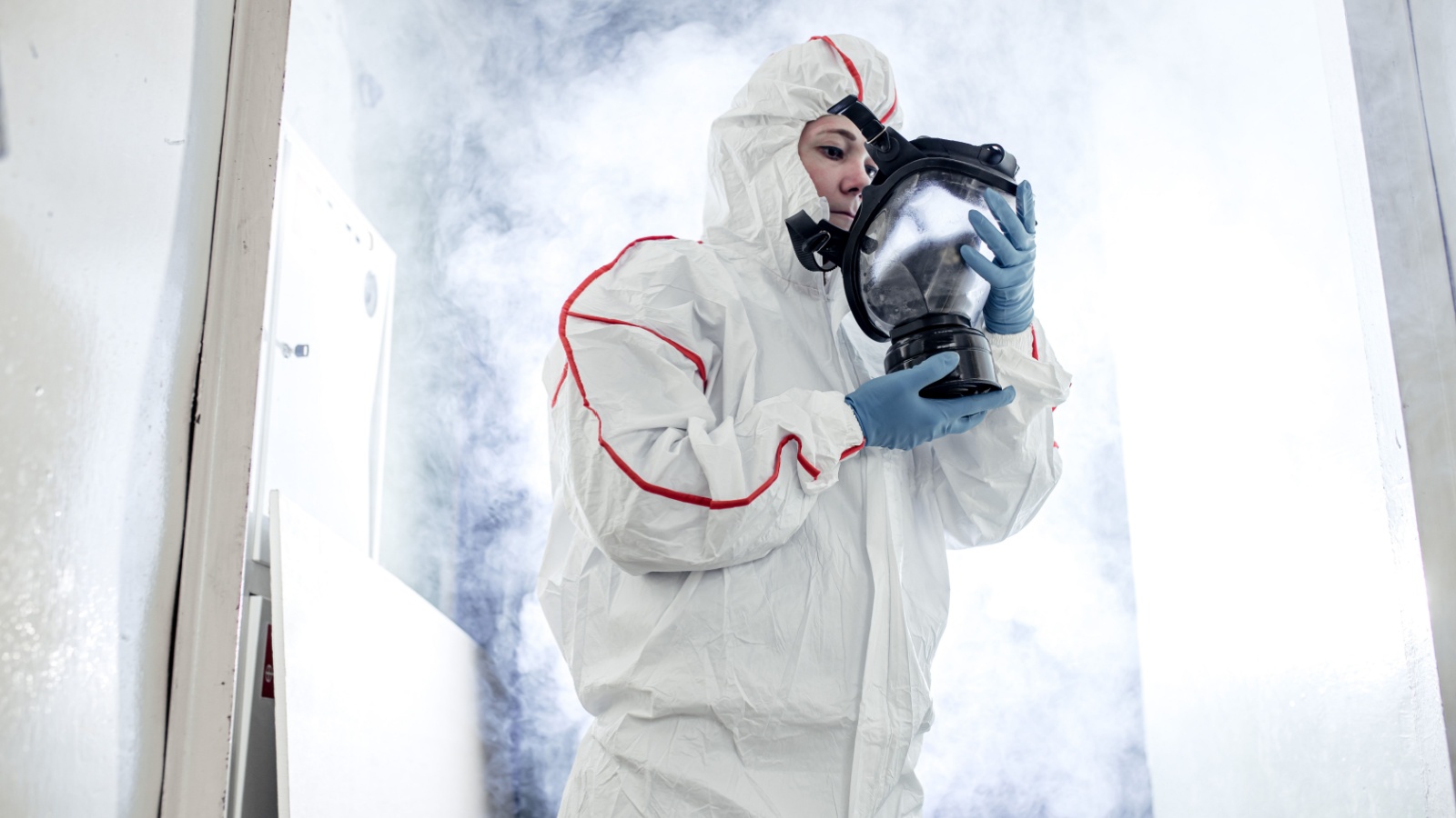 lady in protective hazmat suit and gas-mask against coronavirus, disinfect areas, pathogen respiratory quarantine coronavirus COVID-19 , decontamination