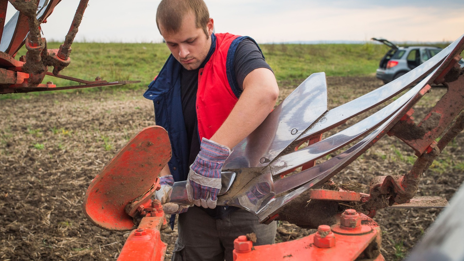 farmer fixing his machinery