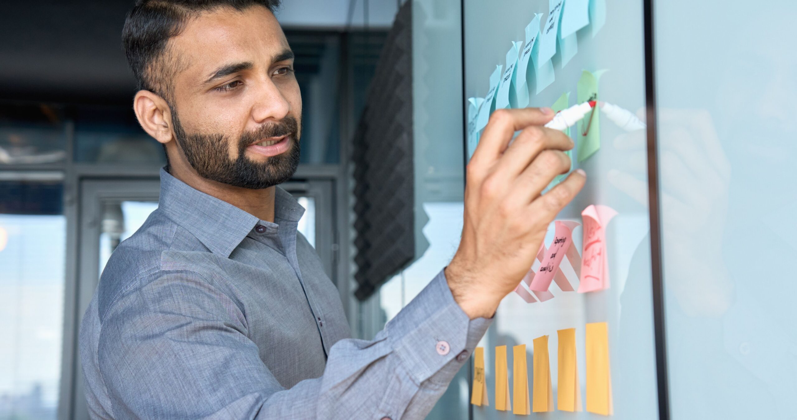 Man writing on sticky notes, list