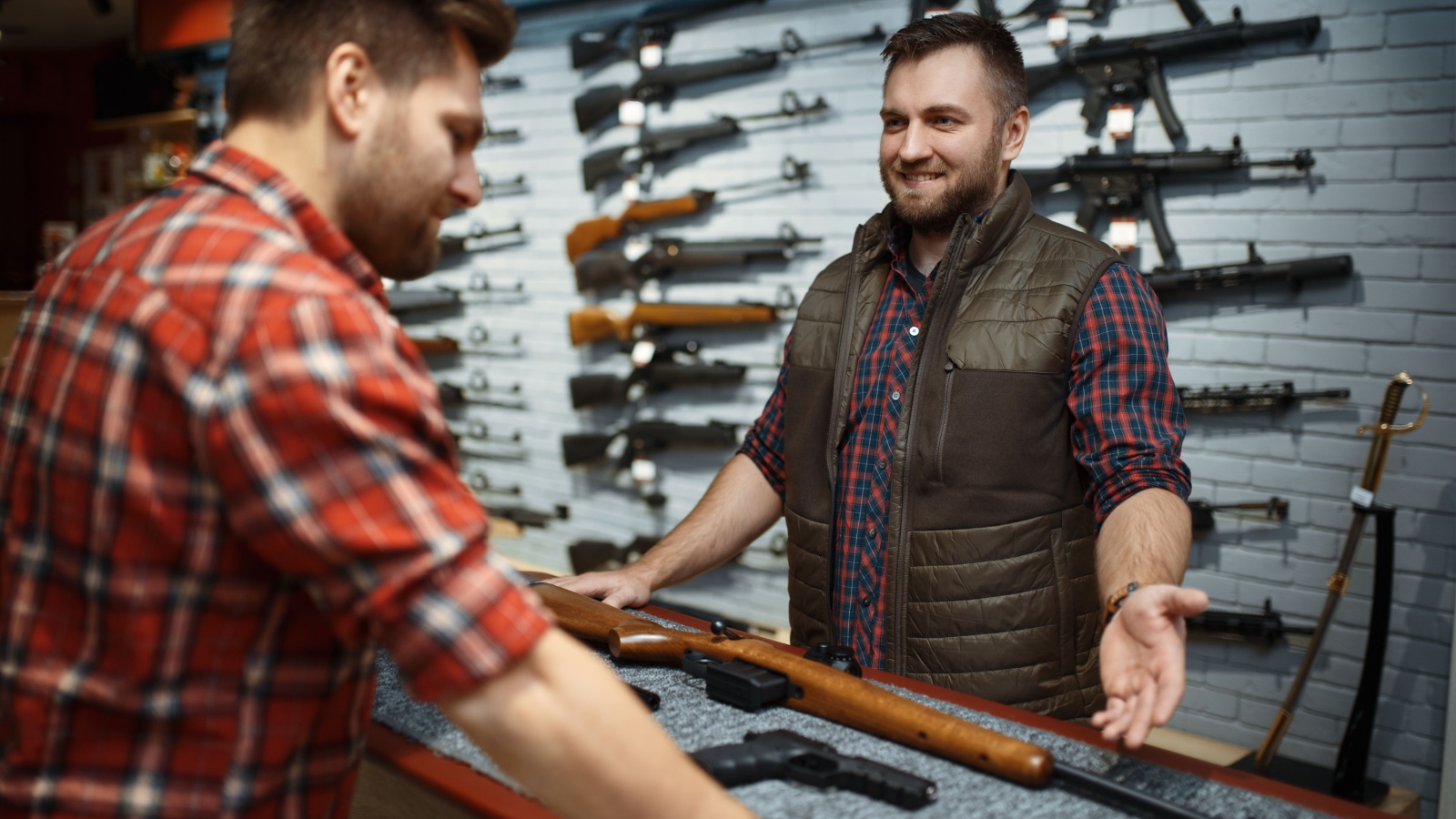 Man looking at guns in a shop