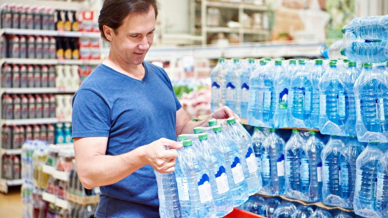 Man stocking up on water bottles, crisis