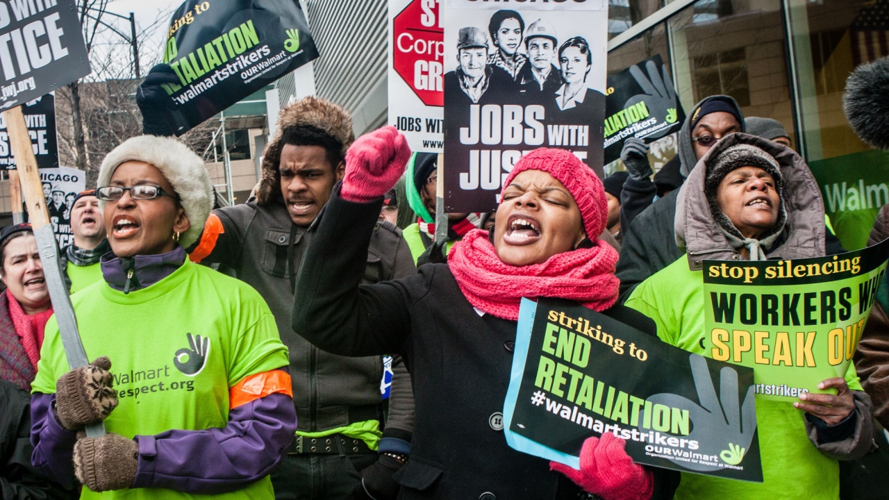 Striking workers and supporters protest against low wages and charge that Walmart retaliates against employees who push for better working conditions.