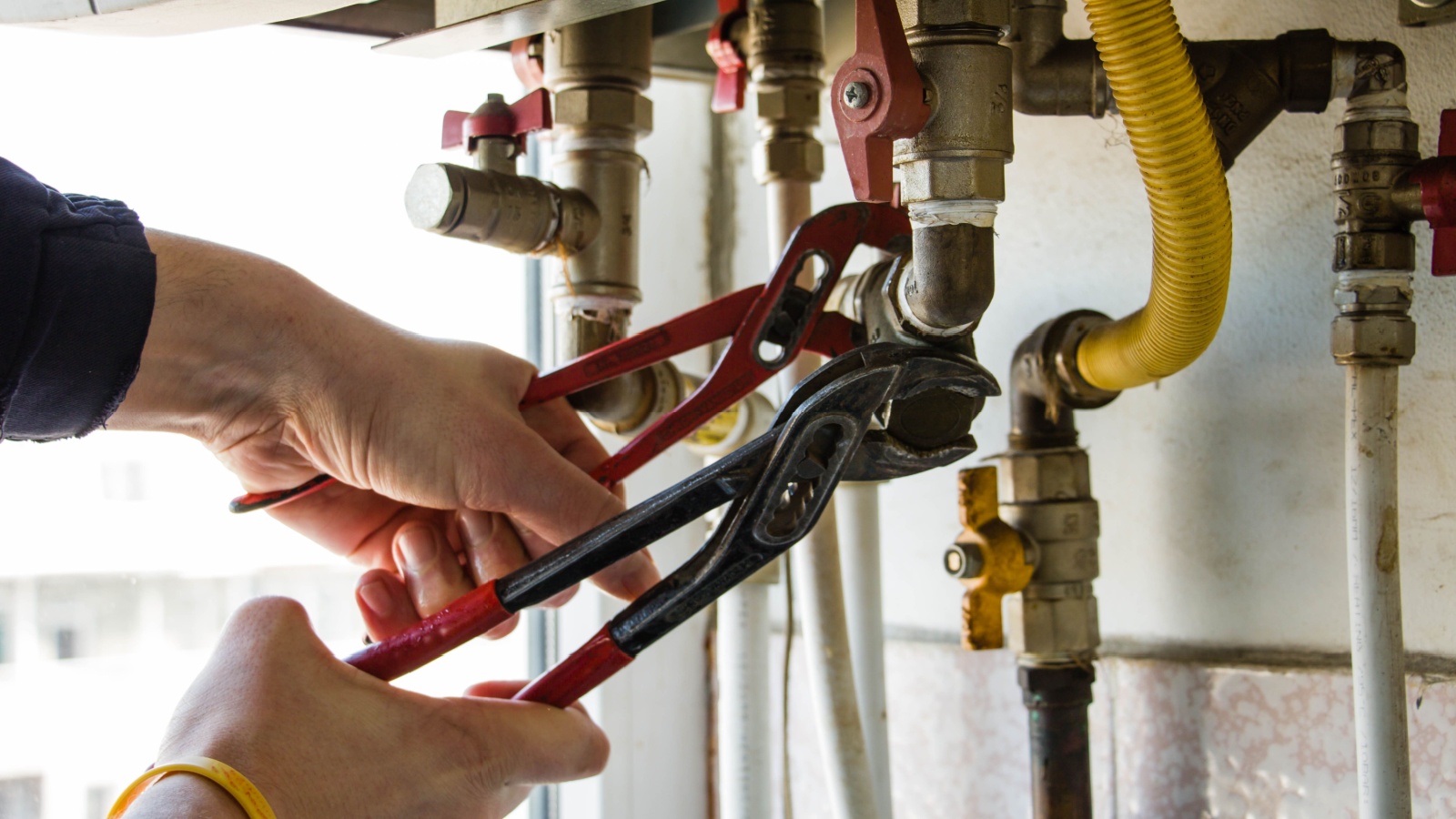 Man turning gas appliance off