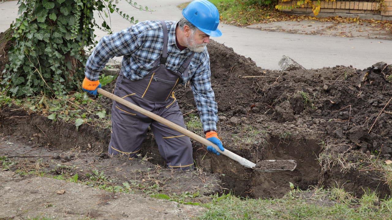 Man digging a hole with a shovel