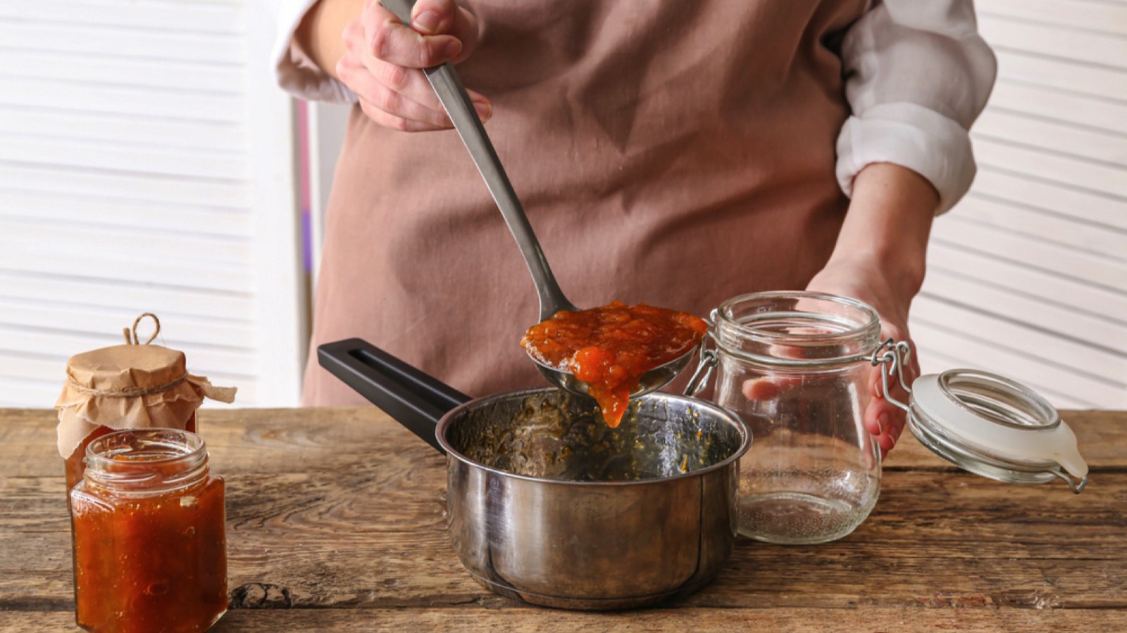 Woman preparing peach jam