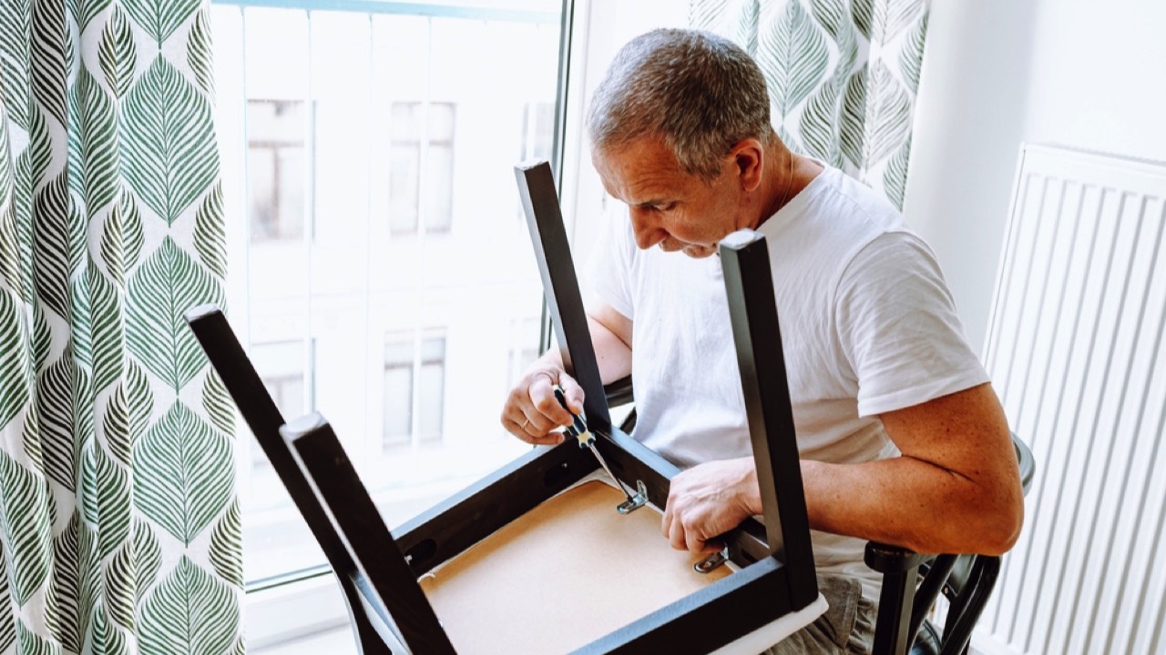 Man fixing broken chair