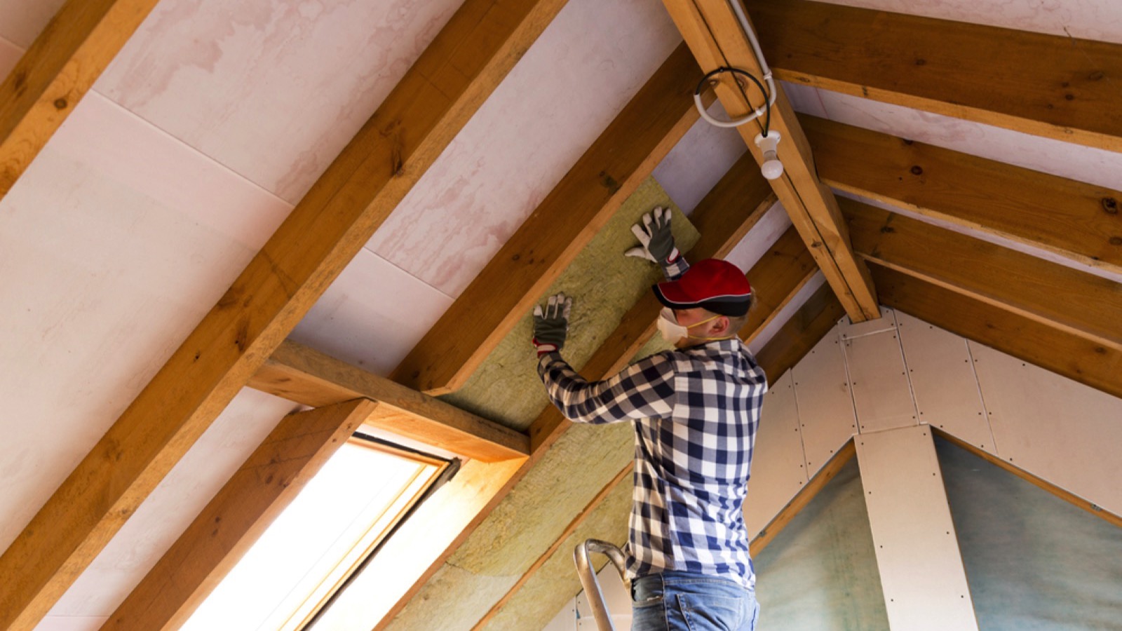 Man installing thermal roof insulation layer