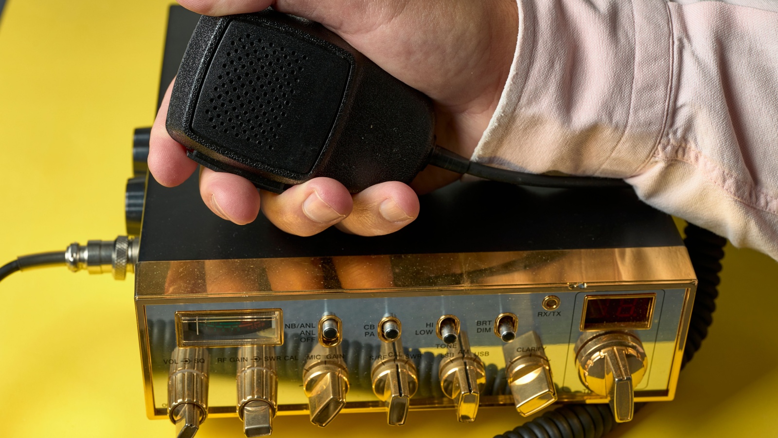 Man's hand with a microphone of a CB radio amateur station