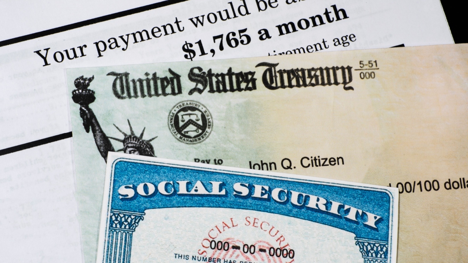 A Corner of Social Security Administration annual statement showing benefits amount at full retirement age with check and ssn card. Concept of retirement planning.