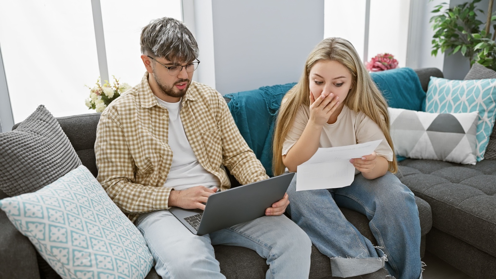 couple looking at bank statement shocked, scam, phishing