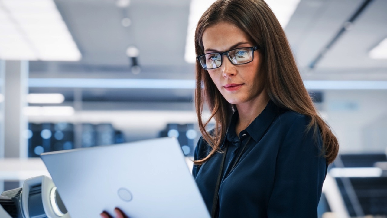 Woman in office using laptop