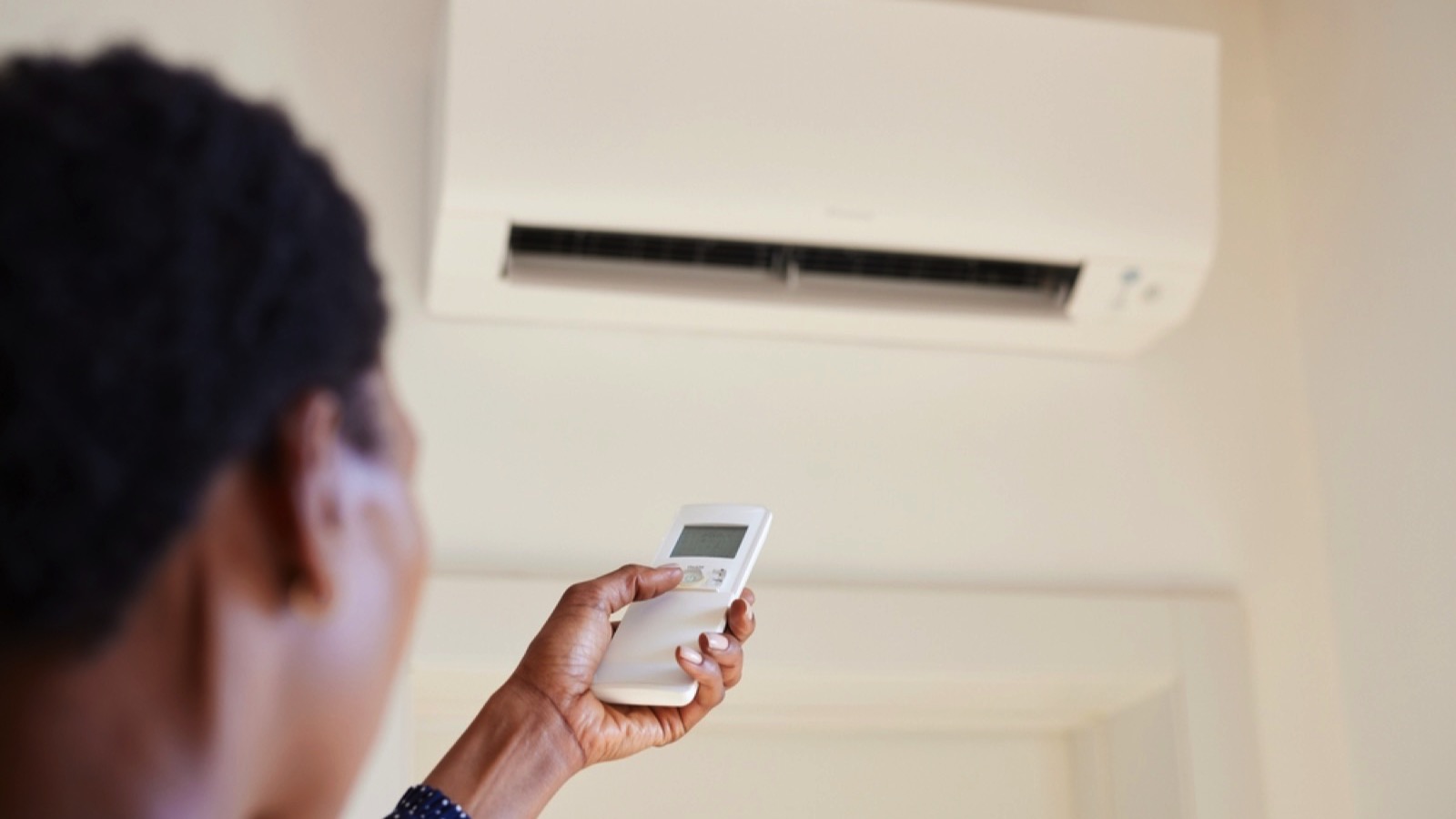 Woman turning on AC