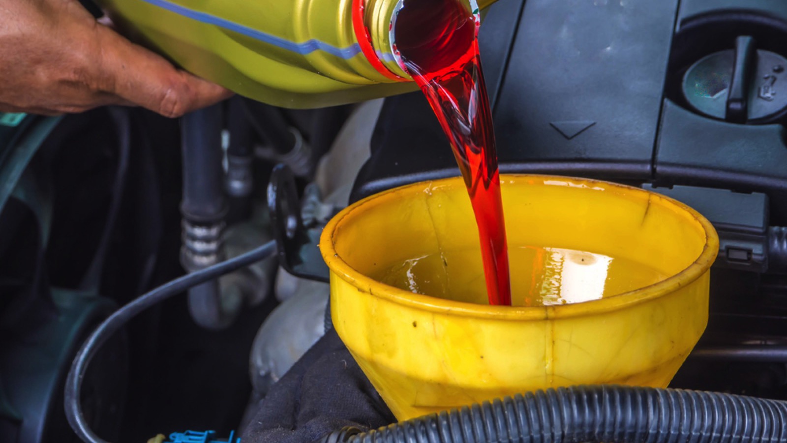 hand fill up in a car engine with transmission oil