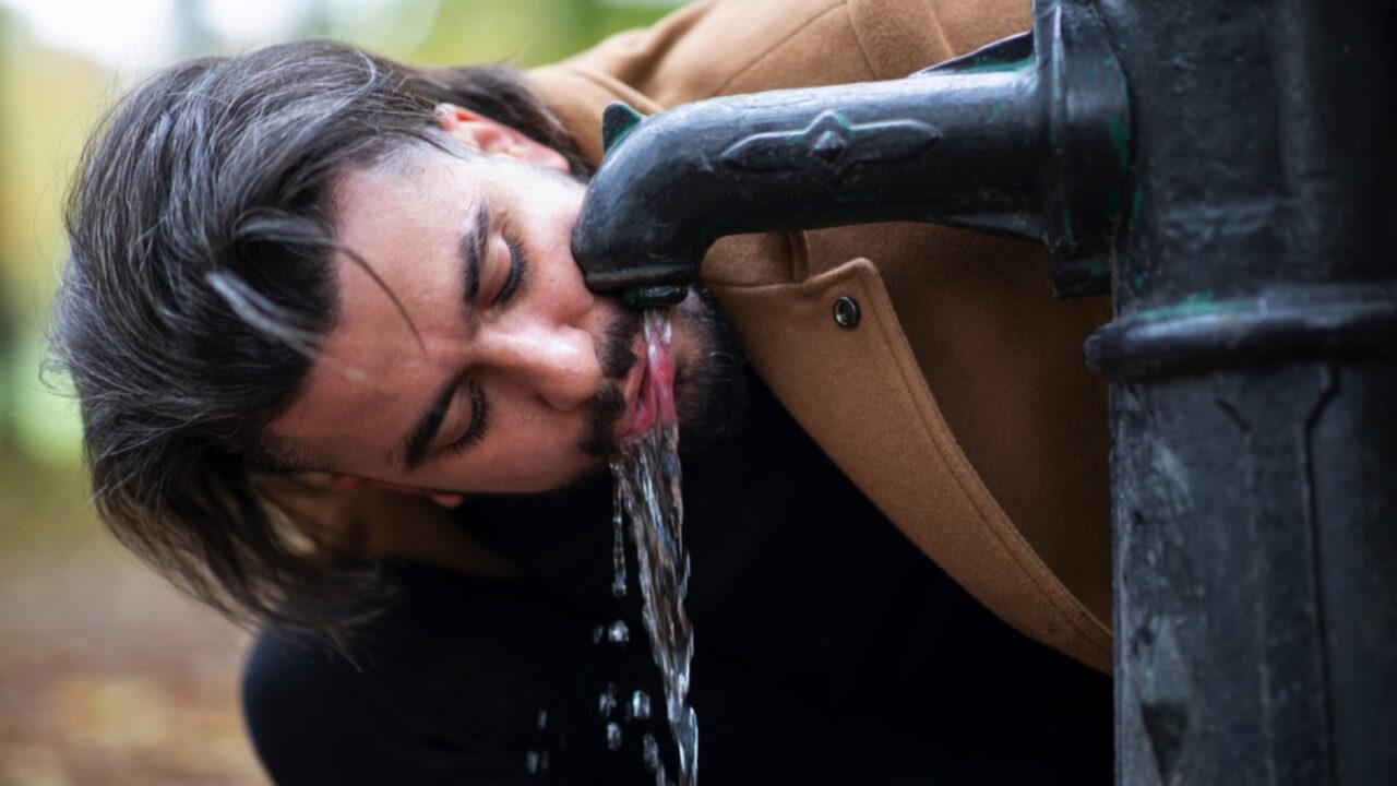 Man drinking tap water