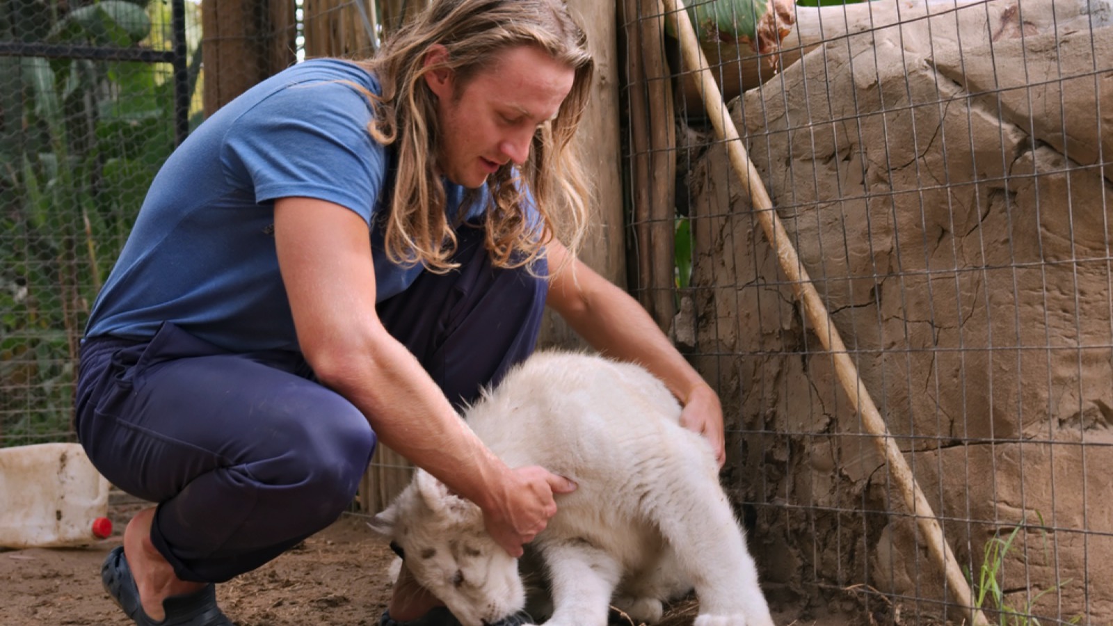 Man with white lion cub