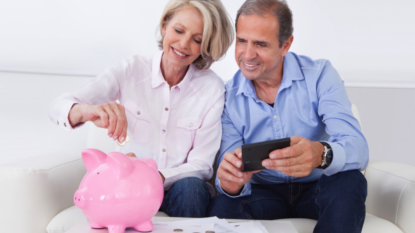 Old couples saving in piggy bank