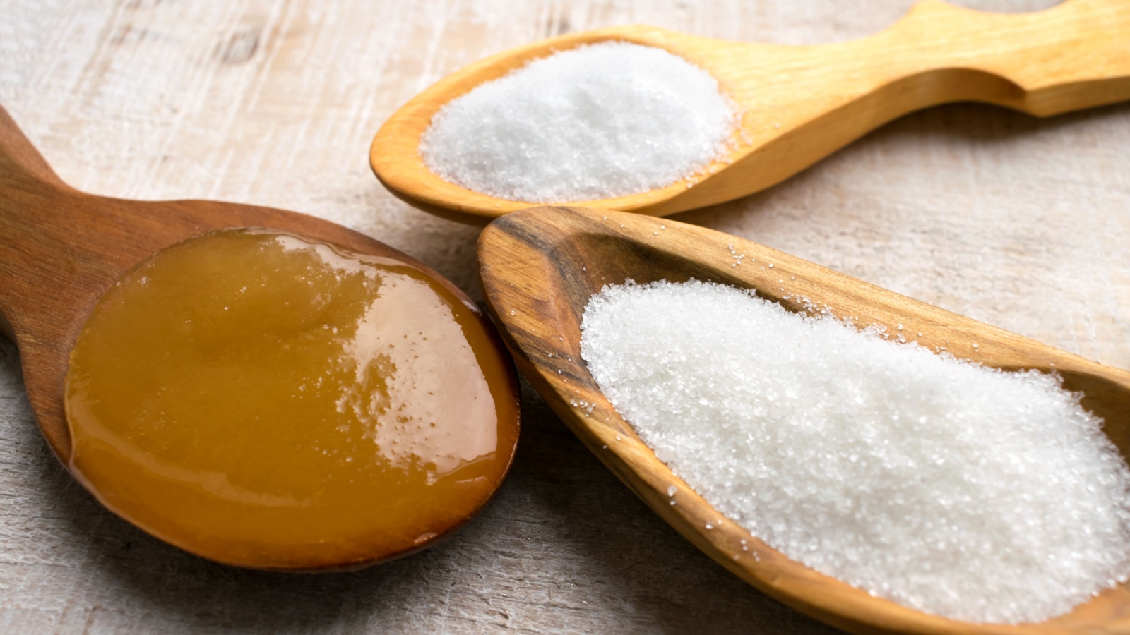 Artificial Sweeteners and Sugar Substitutes in wooden spoons. Natural and synthetic sugarfree food additive: sorbitol, fructose, honey, Sucralose, Aspartame