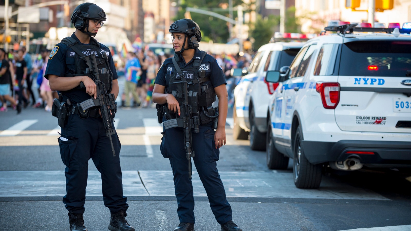 NYPD police officers stand with hands on their weapons, providing security 