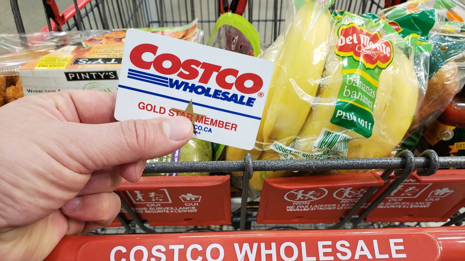 Costco Membership card on a cart in Costco warehouse. Costco is an American corporation which operates a chain of membership only warehouses.