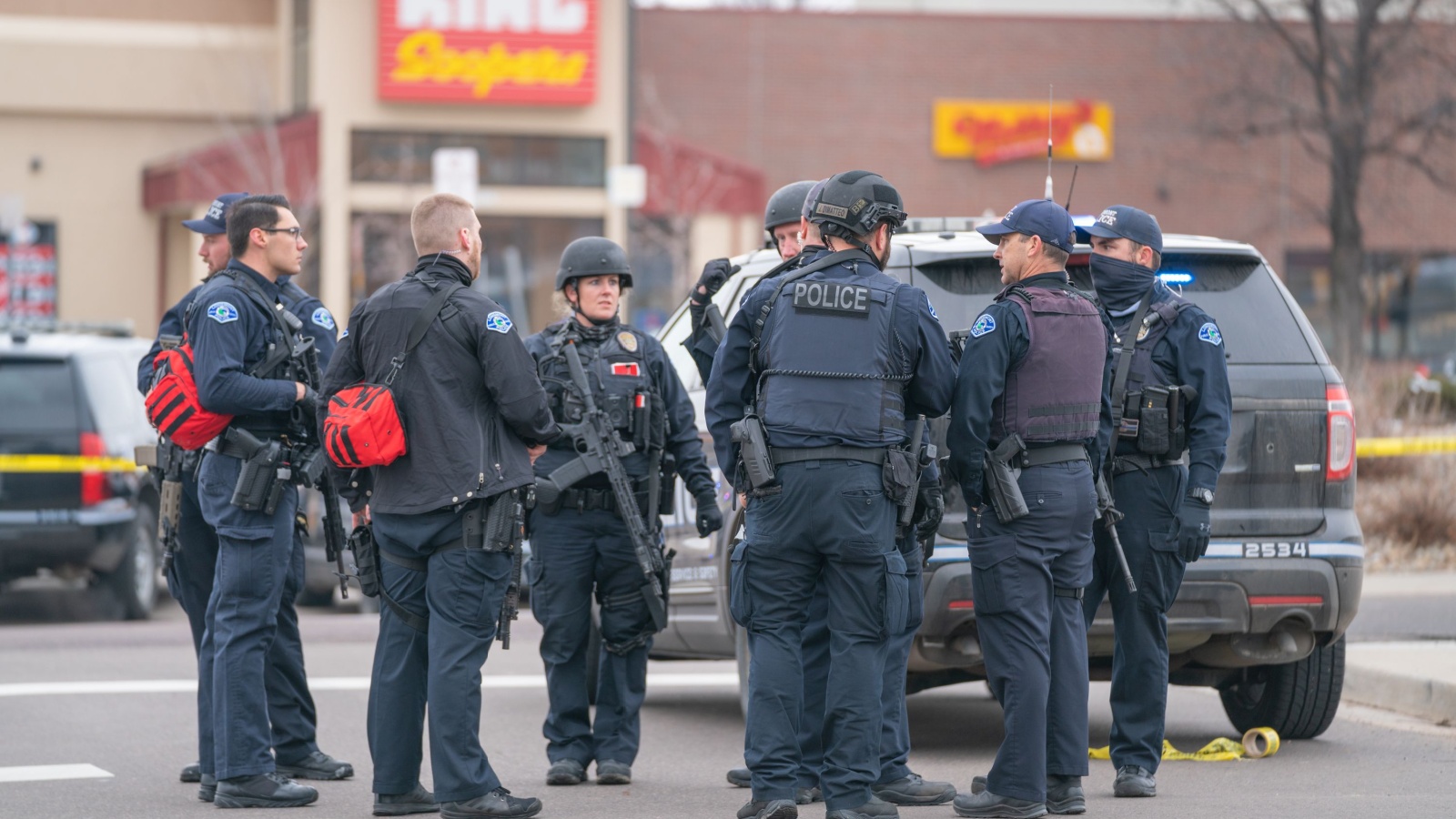 Police officers standing around wearing guns