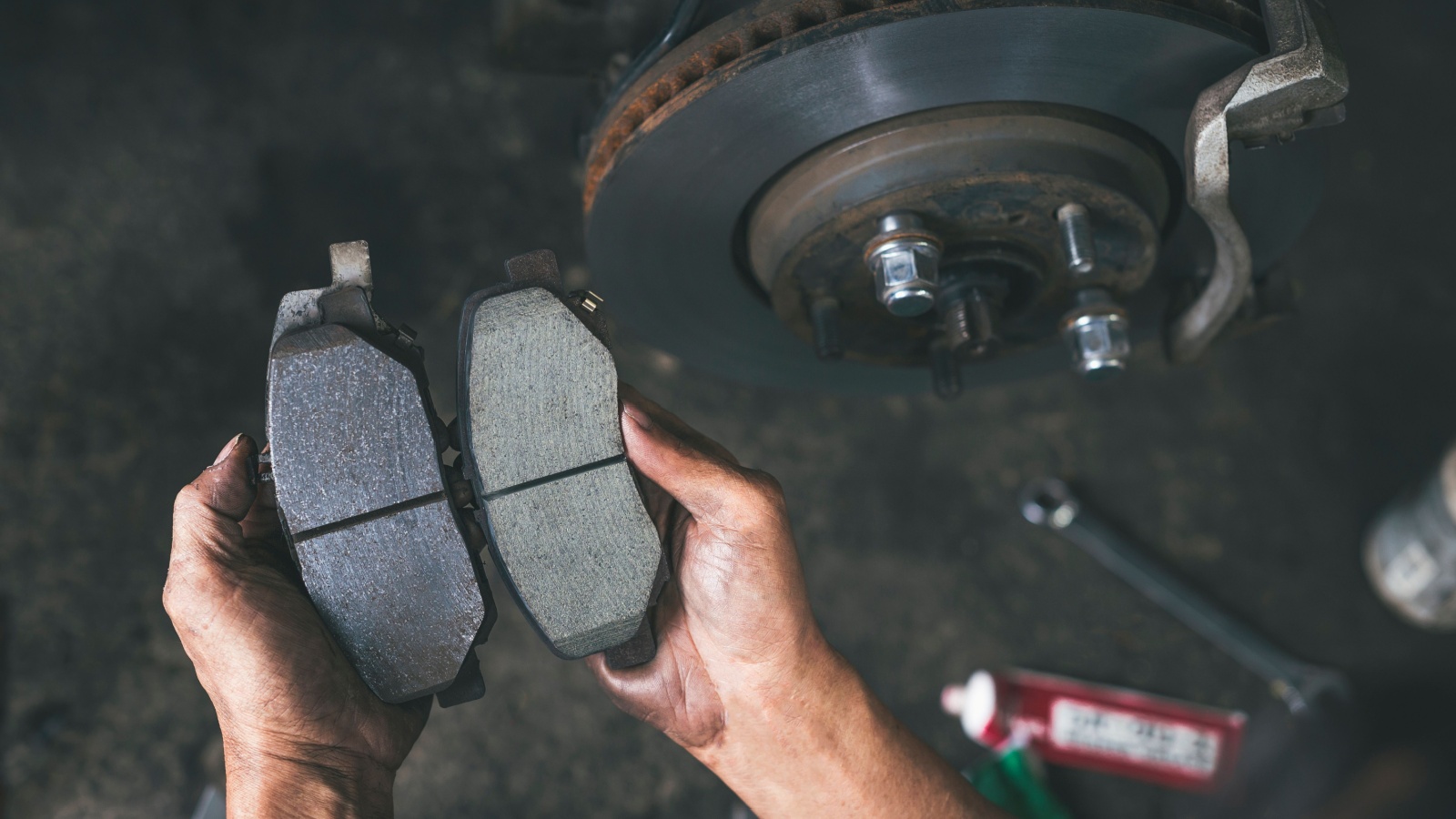 New car brake pads compared to old used brake pads.