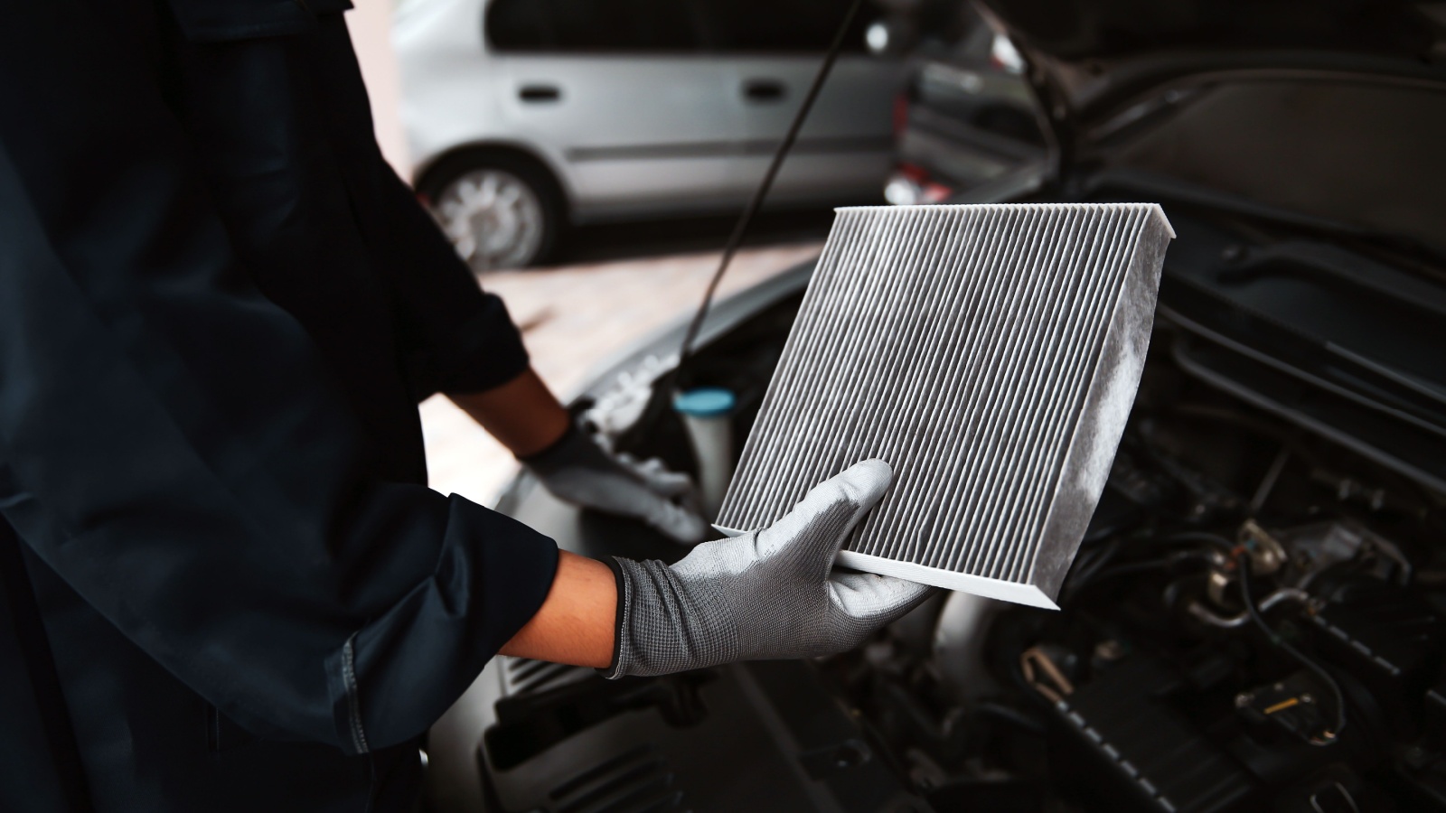 Car air conditioner system maintenance, Hand mechanic holding car air filter to check for clean dirty or fix repair heat have a problem or replace new or change filter.