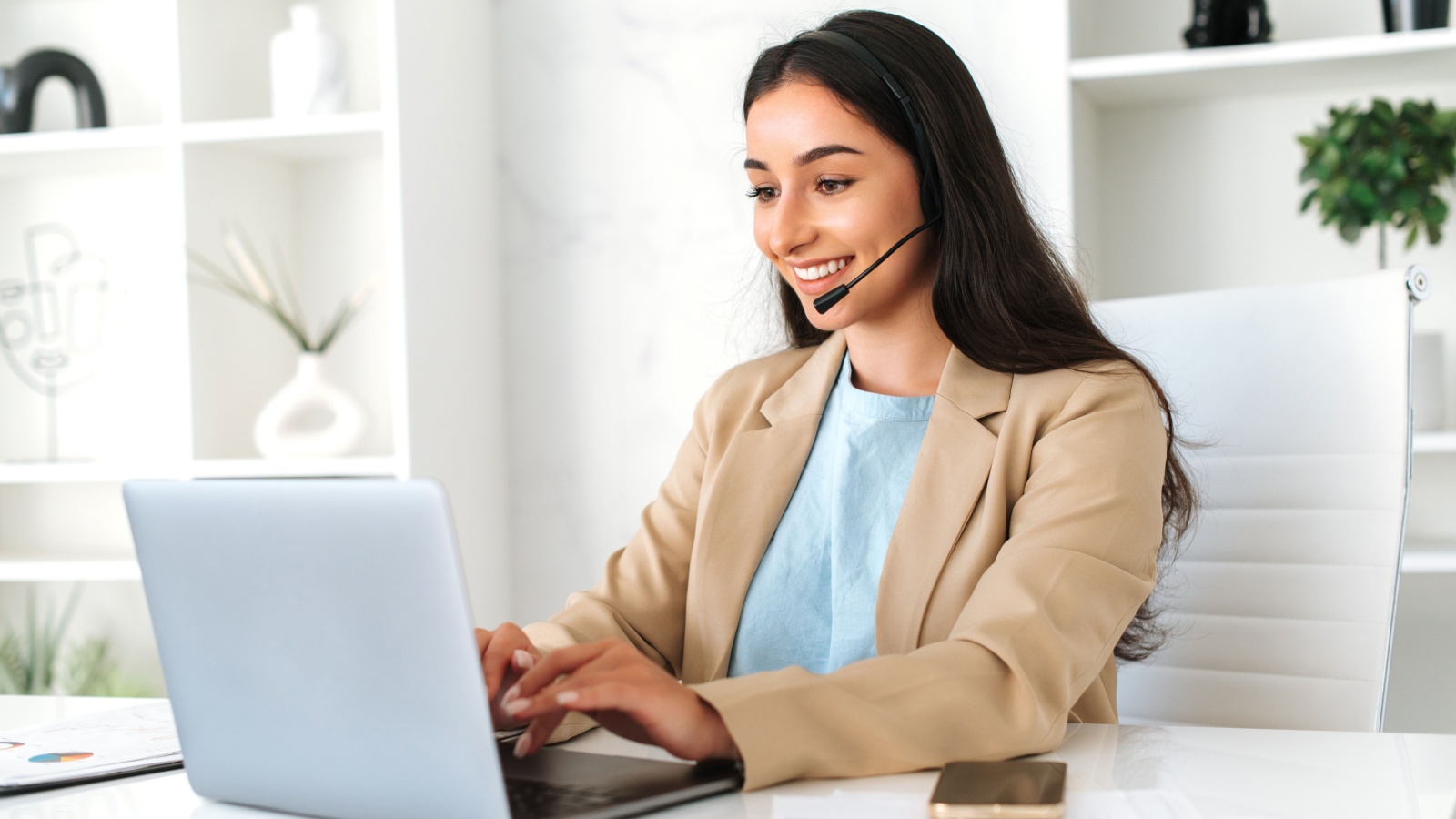 call center operator with headset, working on support help desk in the office with a laptop, smiling. Customer support service, virtual assistant