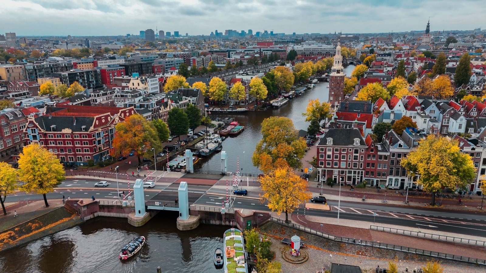 Aerial drone view Amsterdam autumn cityscape narrow old houses, canals, boats 