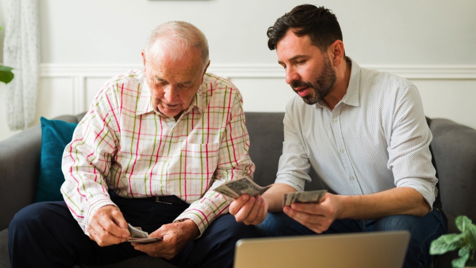 Son giving money to old father