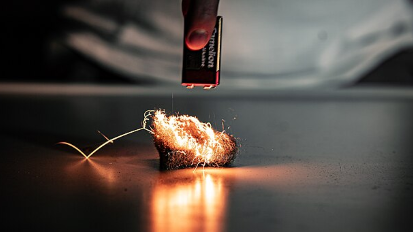 short circuit created when a battery touches steel wool to generate heat.