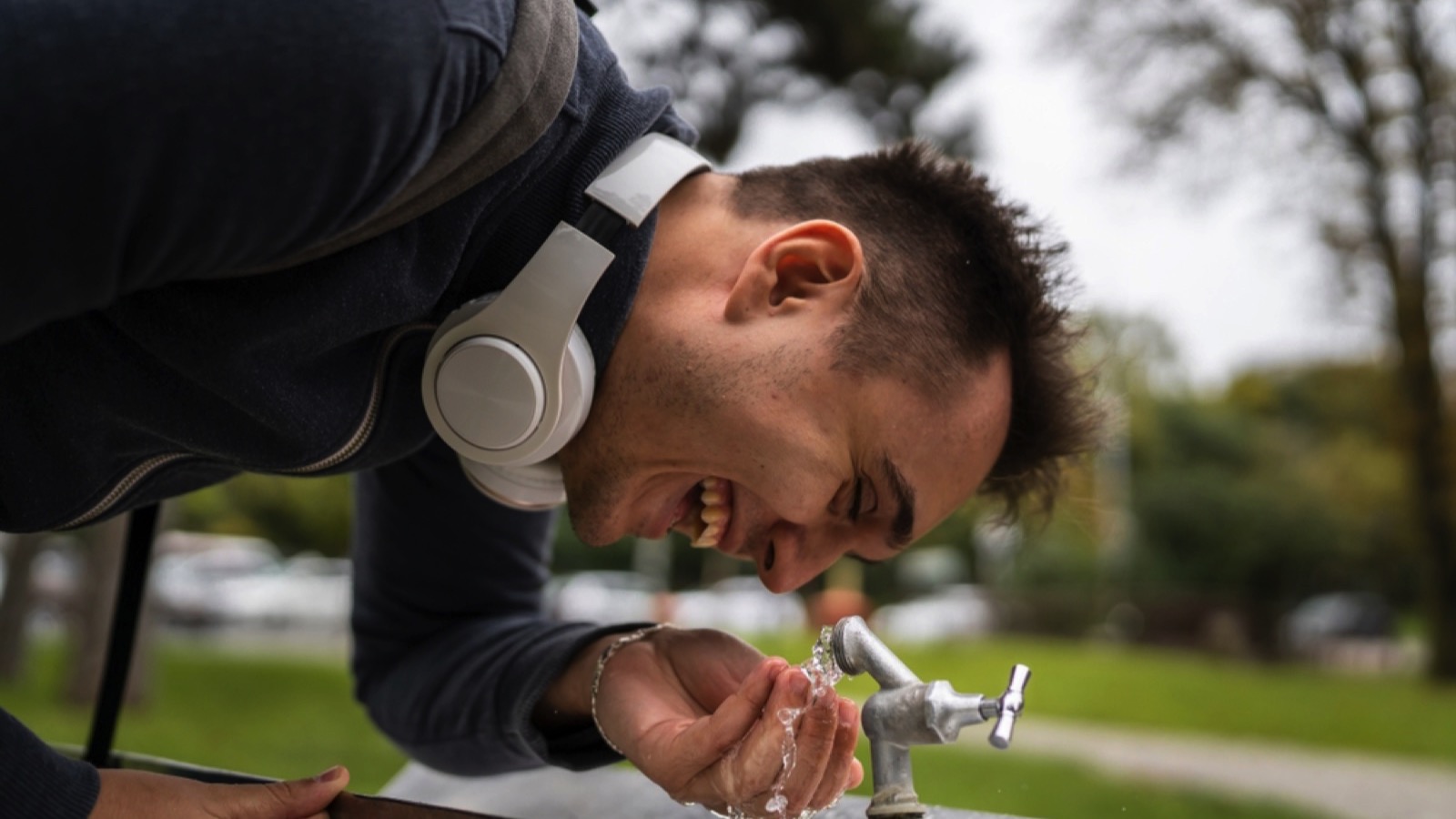 Tourist man drinking tap water