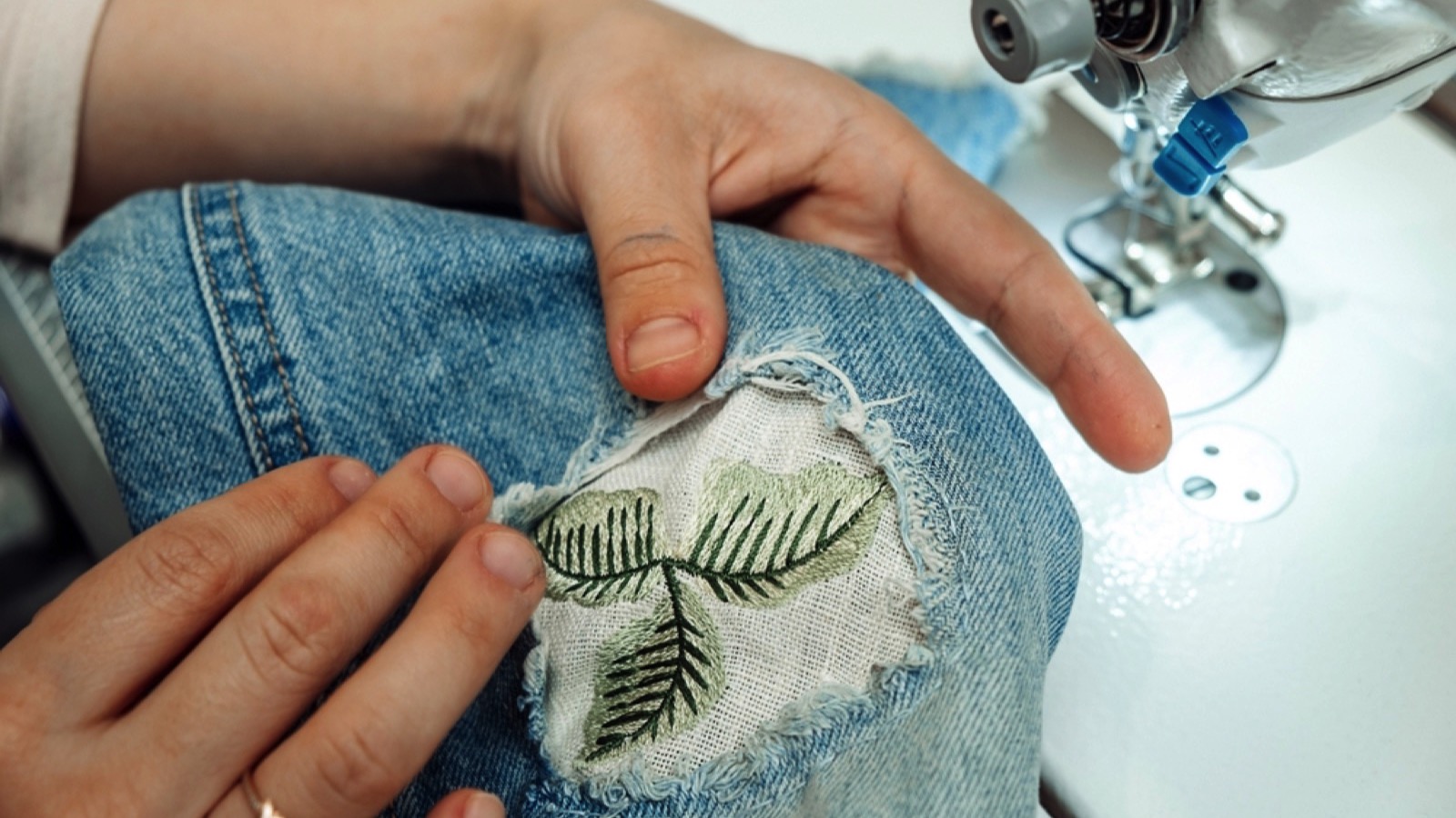 Woman mending jeans