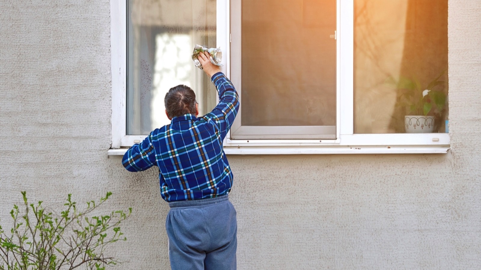 Woman using newspaper for cleaning